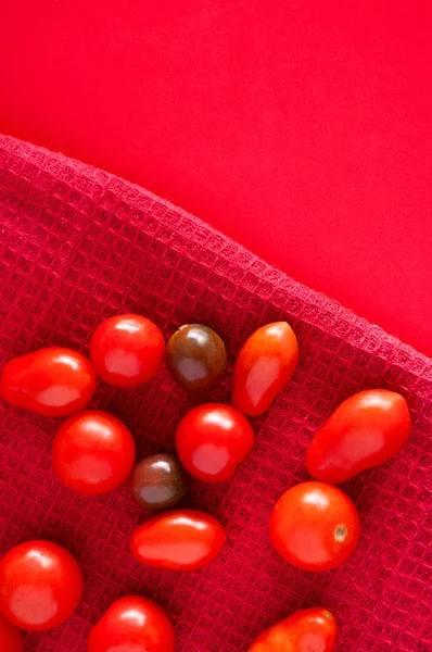 Cherry tomatoes on red