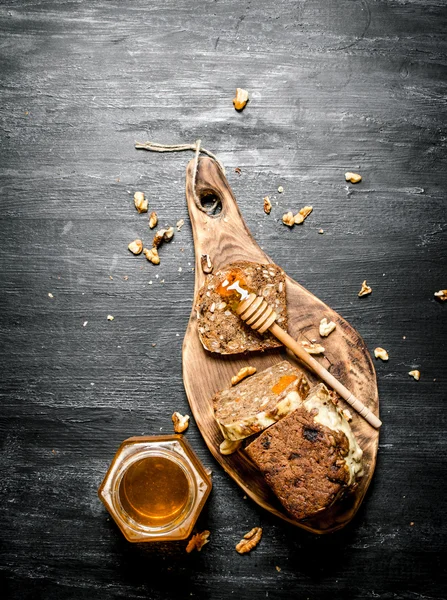 Honey background. Fruit bread with natural honey and walnuts.