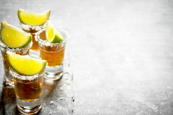 Tequila shots with lime and salt .