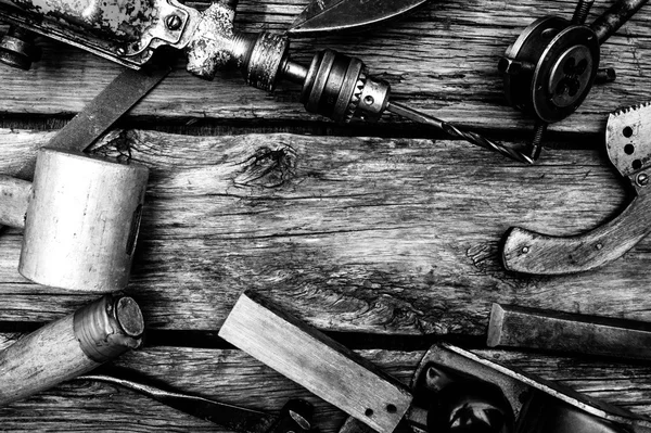 Vintage working tools on wooden background.