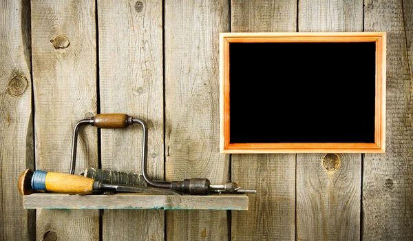 Many old tools and frame on a wooden background.