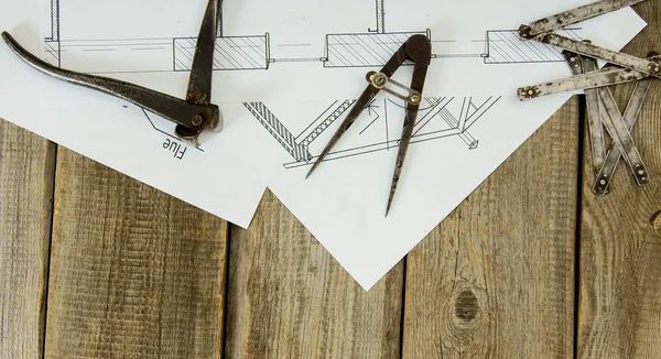 Many drawings for building and working tools on old wooden background.
