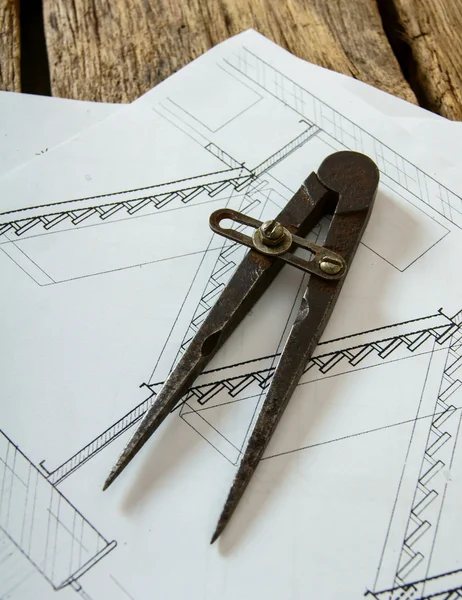 Many drawings for building and working tools on old wooden background.