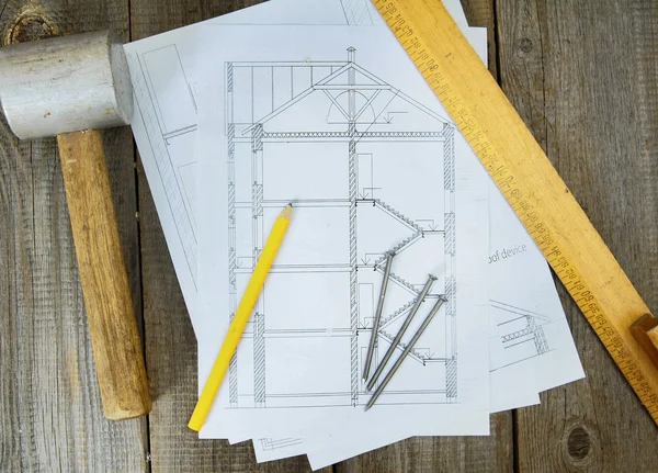 Joiners works. Drawings for building and working tools on wooden background.