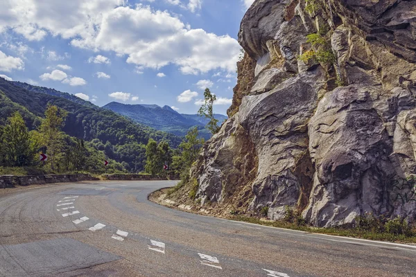 Road turn along steep rocky cliff