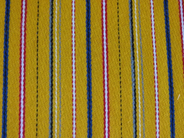 Yellow, white, blue and red striped fabric