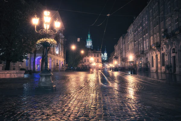 Vintage style image of old European city at night