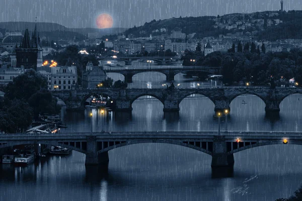 Prague cityscape and full moon at rainy night