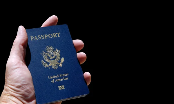 Hand holding American passport