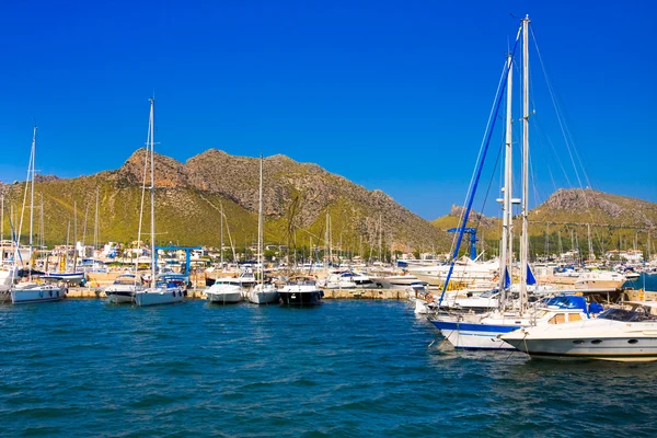 POLLENCA PORT, MAJORCA- AUG 22: Yacht and boats anchored in port on 22 August 2014 on Mallorca island.Many artists and celebrities chose Port de Pollenca as their home.