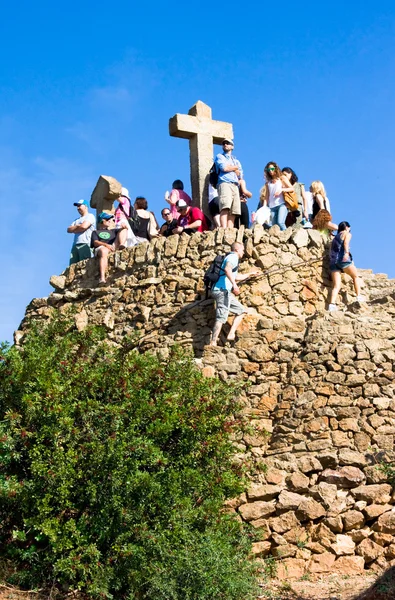 BARCELONA, SPAIN - OCT,19: Tourists on Hill of Three Crosses or monument to Calvary in Park Guell.Park Guell is famous architectural town art designed by Antoni Gaudi and built in years 1900 to 1914