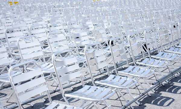 Rows of empty metal chair seats installed for some business event or performance,festiva