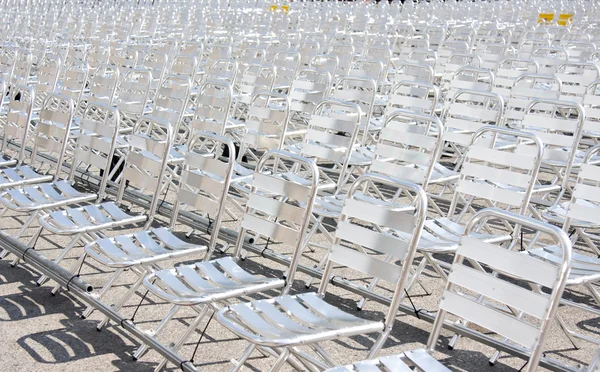 Rows of empty metal chair seats installed for some business event or performance,festiva