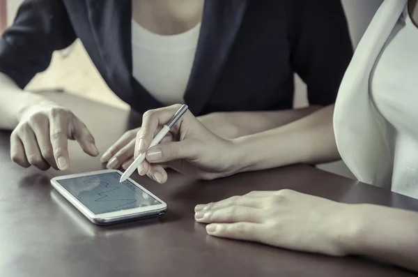 Women using tablet with stylus pen