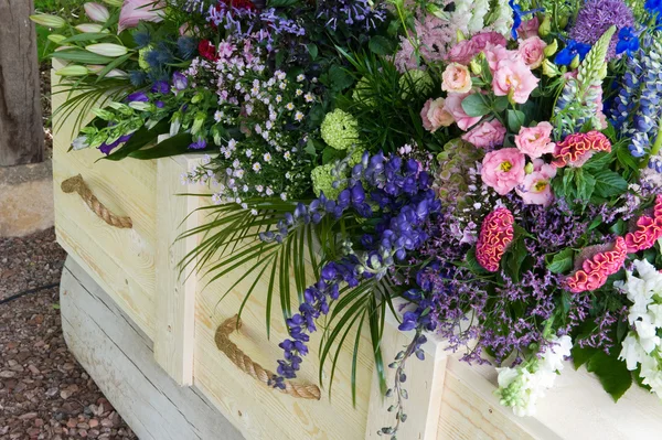 Coffin with flower arrangement