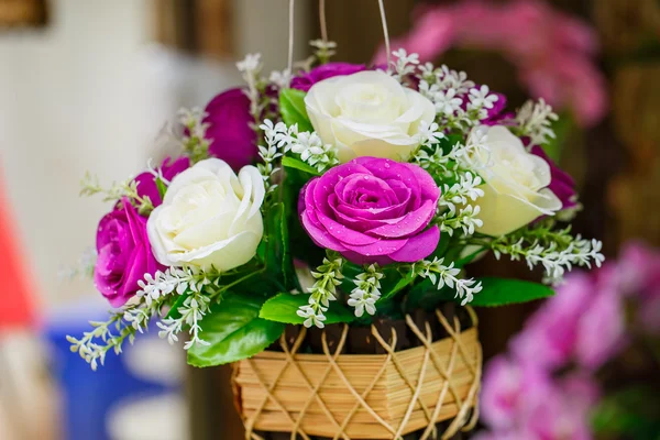 Purple roses with white roses.