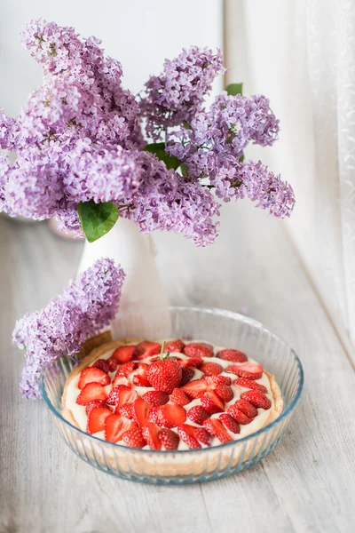 Lilac bouquet and strawberry dessert