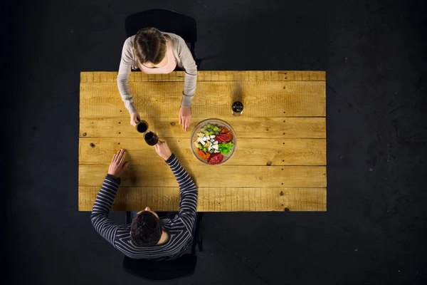 Top view of couple at table with food