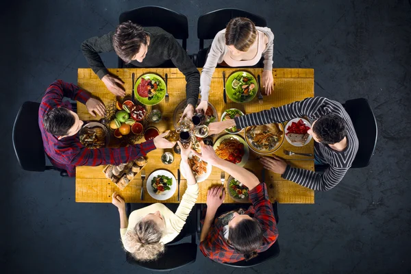 Top view of friends at table with food