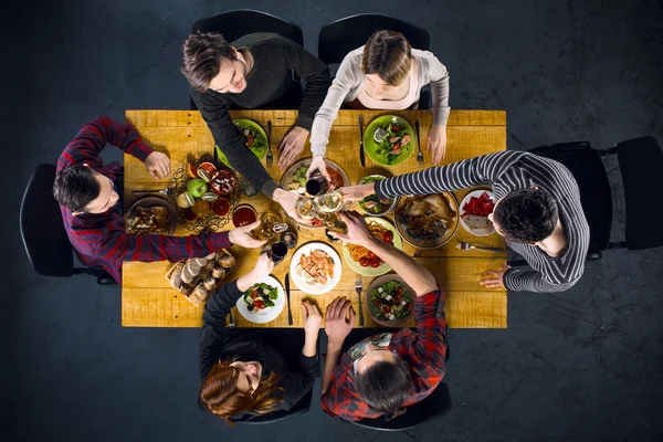 Top view of friends at table with food