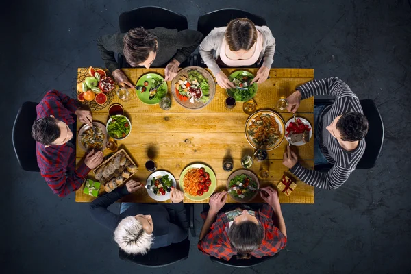 Top view of friends at table with food