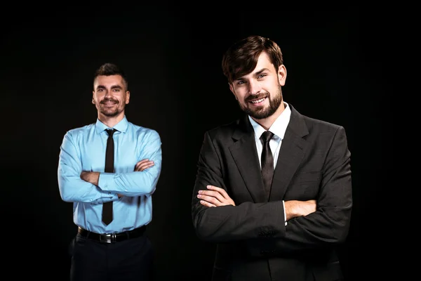 Handsome businessmen on black background