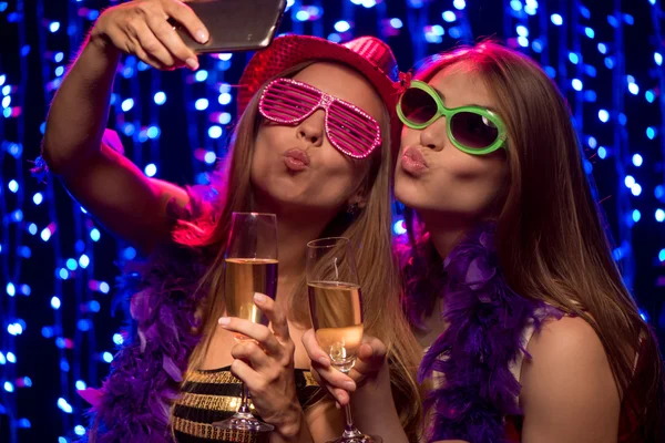 Two party girls with glasses of shampagne