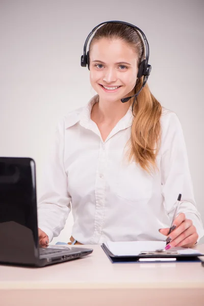 Smiling young woman with headset