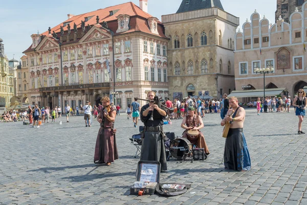Street performers in costume play Celtic in  Old Town Square in