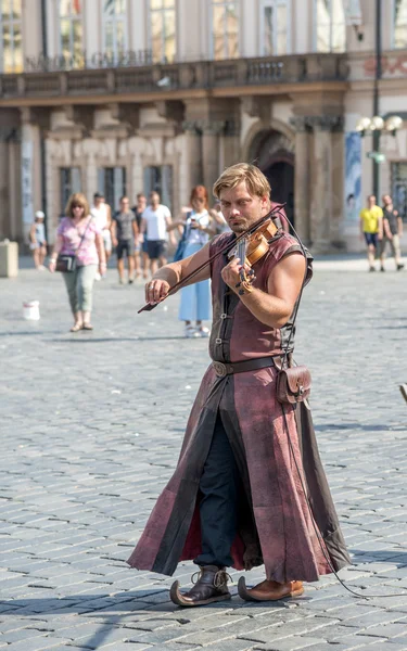 Street performers in costume play Celtic in  Old Town Square in