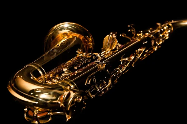 Lying saxophone on black background