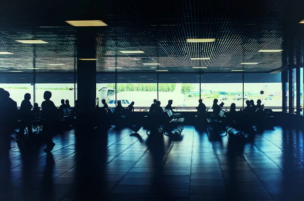 Toned photo of people waiting for departure in the airport