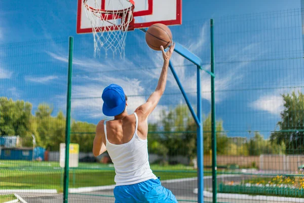 Young guy is playing basketball