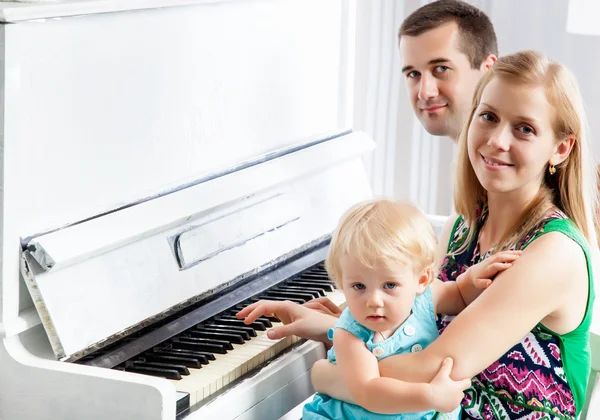 Happy family near the piano