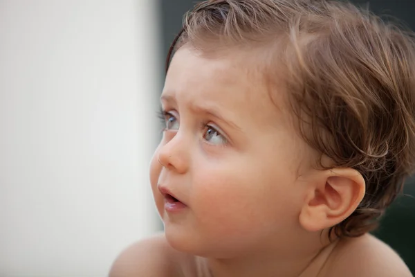 Beautiful baby outside with wet hair