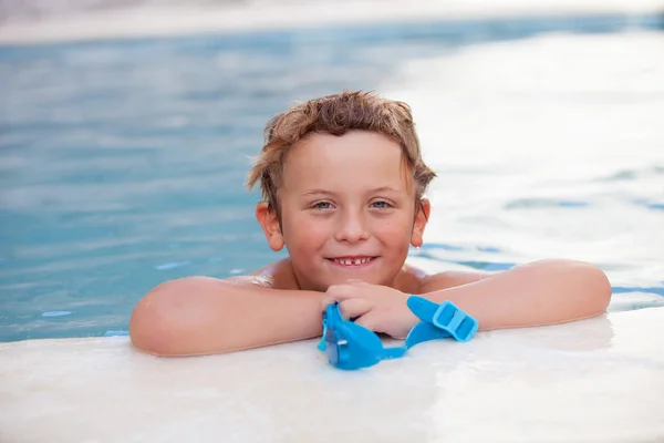 Funny blond boy in the pool