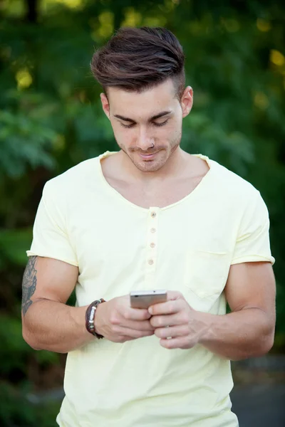Attractive man with mobile phone in the park