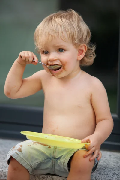 Happy boy eating chocolate cake