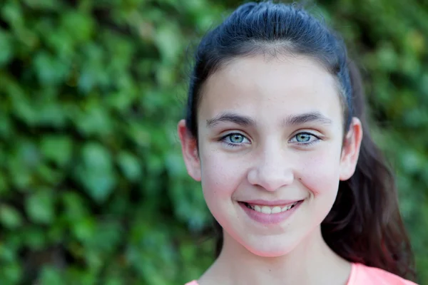 Happy preteen girl with blue eyes smiling