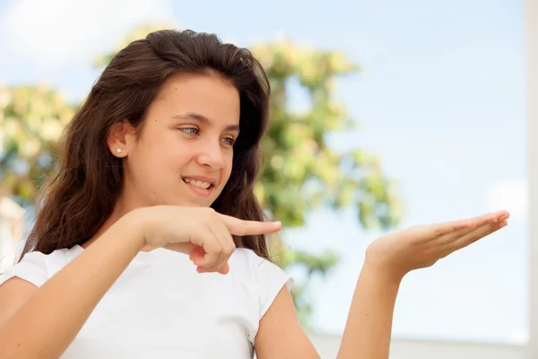 Teenager girl pointing her hand