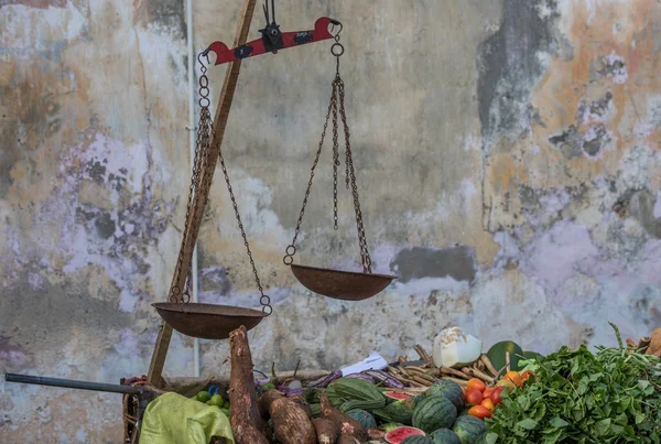 Street stall with vegetables and scales