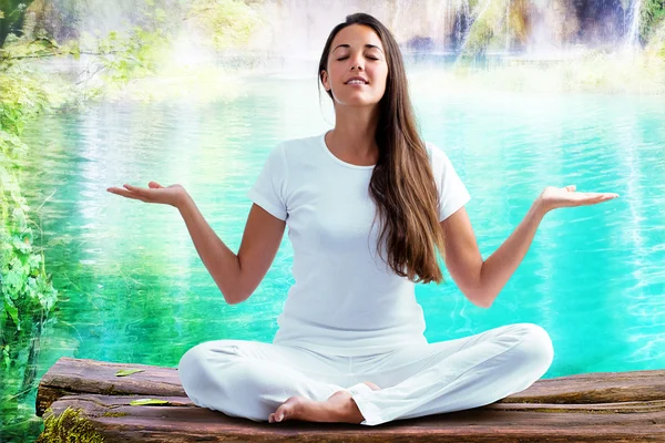 Woman doing yoga exercise at lake