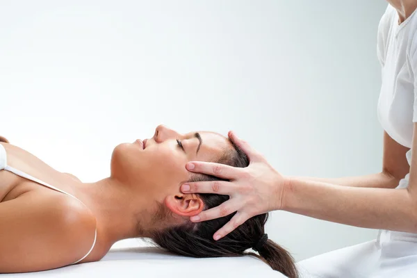 Healing osteopathic treatment on woman.