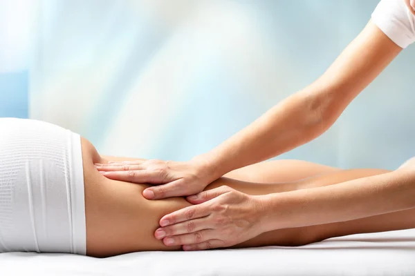 Therapist massaging  female leg