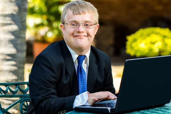 Handicapped businessman working with laptop