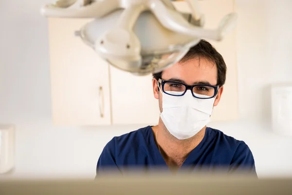 Young dentist in his medical practice