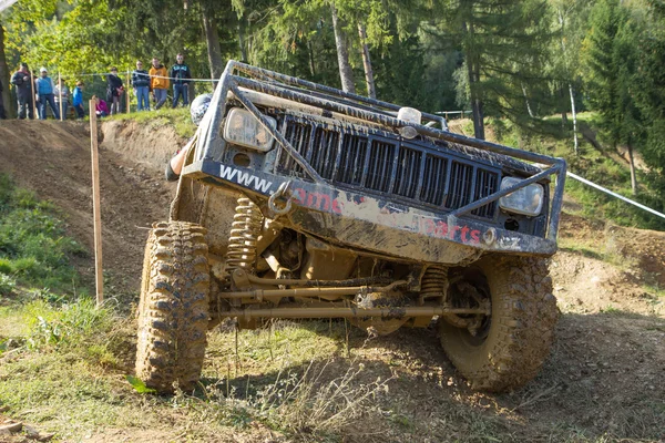 Big off road car is hitting a steep hil