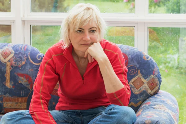 Thoughtful blonde middle aged woman