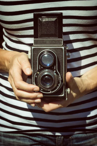 Vintage photo of woman holding old camera