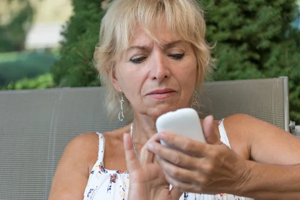 Senior woman is learning to use her smartphone
